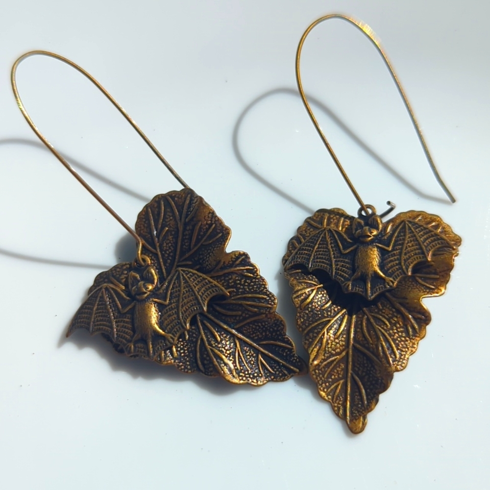 Gold bat and leaf earrings